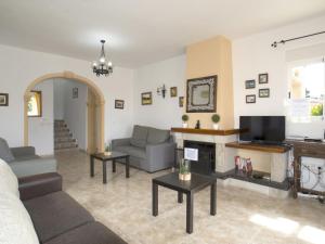 a living room with a couch and a fireplace at Villa Acuario by Interhome in Calpe