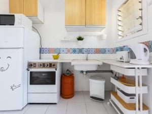 a small kitchen with white appliances and a sink at Apartment Tabor-1 by Interhome in Torredembarra