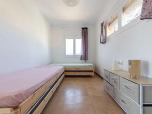 a bedroom with a bed and a window at Apartment Tabor-1 by Interhome in Torredembarra