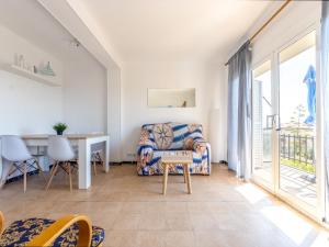 a living room with a chair and a table at Apartment Tabor-1 by Interhome in Torredembarra