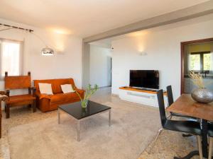 a living room with a couch and a tv at Holiday Home La Marina by Interhome in Benissa