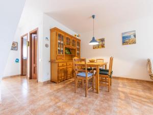 a kitchen and dining room with a table and chairs at Holiday Home Boters-1 by Interhome in Torredembarra +23 photos