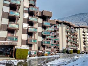 a large apartment building with snow on the ground at Studio Castel des roches A36 by Interhome in Saint-Gervais-les-Bains
