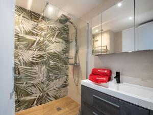 a bathroom with a shower and a red towel at Studio Les Pradels by Interhome in Cavalaire-sur-Mer