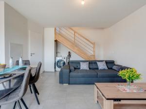 a living room with a couch and a table at Apartment Soleil Couchant B03 by Interhome in Mimizan +26 photos