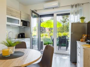 a kitchen with a table with a yellow umbrella at Apartment Juventus by Interhome in Balatonföldvár