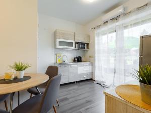 a kitchen and dining room with a table and chairs at Apartment Juventus by Interhome in Balatonföldvár