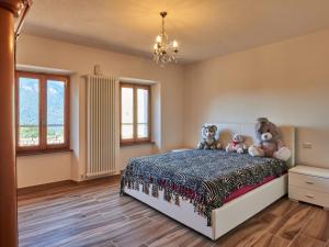 een slaapkamer met een bed met knuffels erop bij Holiday Home Matilde e Melissa by Interhome in Naggio