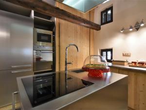 a kitchen with a sink and a counter top at Chalet Baita Barin by Interhome in Madesimo