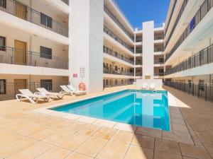 a swimming pool in the courtyard of a building at Apartment Wave Dream by Interhome in Olhão