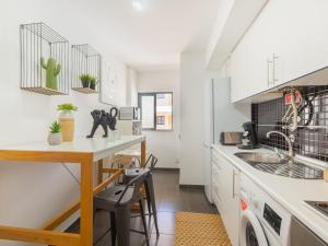 a kitchen with a small table and a sink at Apartment Wave Dream by Interhome in Olhão +13 photos