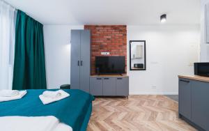 Telewizja i/lub zestaw kina domowego w obiekcie Ice Apartments