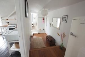 a hallway with a white refrigerator and a kitchen at Cheltenham Road One Bedroom Apartment in Bristol