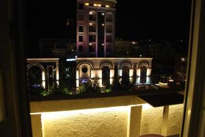 a view of a building at night from a window at Apartment No 5 in Prishtinë
