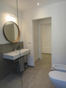 a bathroom with a sink and a mirror and a toilet at Make a wish - near the center with private parking in Como