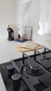 uma placa de fogão na cozinha com uma tábua de cortar em Casa lagunare haus em Chioggia