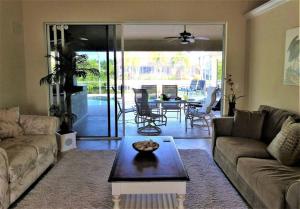 - un salon avec un canapé et une table dans l'établissement SUNNY MORNINGS * 4 bed/2.5 bath * gulf access *, à Cape Coral