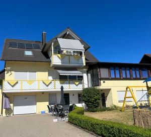 une grande maison jaune avec beaucoup de fenêtres dans l'établissement Familie Ising, à Unterwörnitz