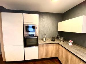 a kitchen with a white refrigerator and a microwave at Wood Luxury House in Pescara +49 photos