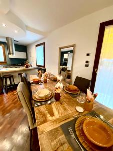 a large wooden table in a room with a kitchen at Wood Luxury House in Pescara