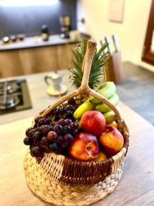 a basket of fruit sitting on a table at Wood Luxury House in Pescara