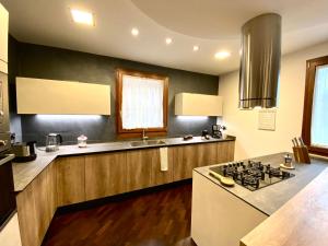 a kitchen with a stove and a sink at Wood Luxury House in Pescara