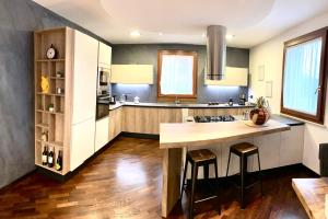 a kitchen with a island in the middle of a room at Wood Luxury House in Pescara