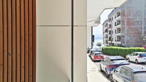 a street with cars parked on the side of a building at BR Silgar Suites in Sanxenxo