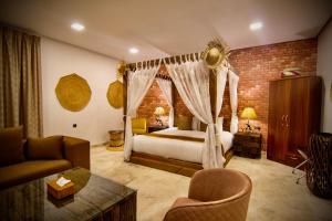 a hotel room with a bed and a living room at Coastline Resort in Al-Musannah