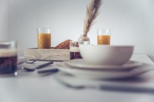 a table with a plate of food and two glasses of beer at Le Bohême Chic Superbe studio + parking Free in Dunkerque