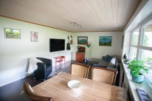 a living room with a table and a couch at Lovely 2- bedroom apartment in central Tórshavn in Tórshavn