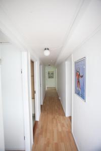 an empty hallway with white walls and wooden floors at Lovely 2- bedroom apartment in central Tórshavn in Tórshavn