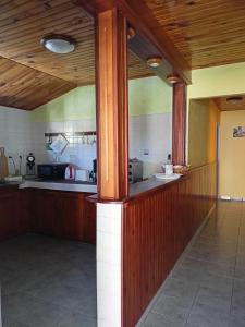 a kitchen with wooden cabinets and a counter top at Petite Fleur de Lentilles 2 in Cilaos