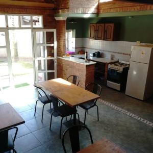 a kitchen with a table and chairs and a refrigerator at La Casa del Paraná - San Pedro in San Pedro