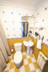 a bathroom with a toilet and a sink at Apartahotel Trébede in Barro de Llanes