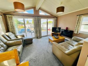 a large living room with couches and a television at Waterfall Retreat in Poole