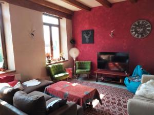 a living room with a couch and a fireplace at La Petite Auberge in Lorquin