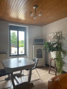 a living room with a table and a fireplace at Cottage Philmaries in Coudert
