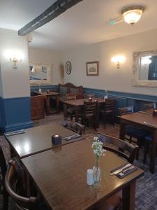 a dining room with wooden tables and chairs at George Hotel in Keswick
