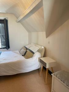 a small bedroom with a bed and a table at Cottage Philmaries in Coudert +24 photos