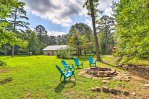 a group of blue chairs sitting around a fire pit at Higden Home with Furnished Porch, Spacious Yard in Fairfield Bay