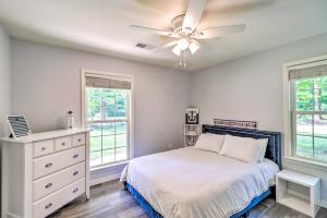 a bedroom with a bed and a ceiling fan at Higden Home with Furnished Porch, Spacious Yard in Fairfield Bay