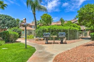 a park with two benches and a fence at Updated Scottsdale Condo Less Than 3 Mi to Old Town! in Scottsdale