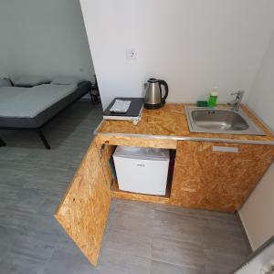 a wooden counter with a sink in a room at Budget Apartment LeLo Center 4 in Osijek