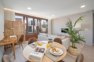 a living room with a table and a couch at Cine Park Residences by An Island Apart in Funchal