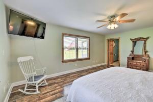 a bedroom with a bed and a chair and a ceiling fan at Pet-Friendly Woodsy Gem quarter Mi to Chesapeake Bay in Exmore