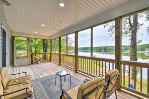 a screened in porch with a view of the water at Relaxing Riverfront Cottage with Boat Dock! in Locklies