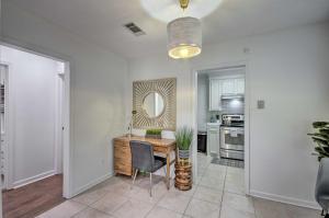 a living room with a desk and a mirror at Updated Jackson Home about 3 Mi to JSU Stadium! in Jackson +22 photos