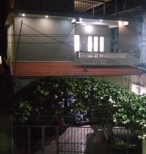 a building with a bunch of plants on a balcony at Spice Cottage Homestay in Thekkady