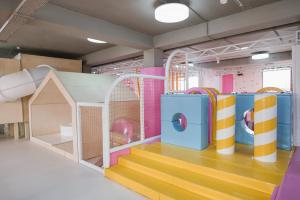 a play room with a slide and a play house at Hotel Zefir in Drohobytsch